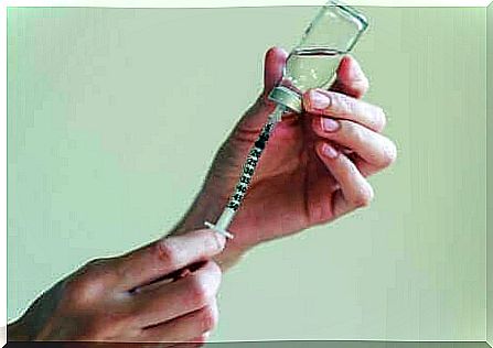 A person is preparing an injection.