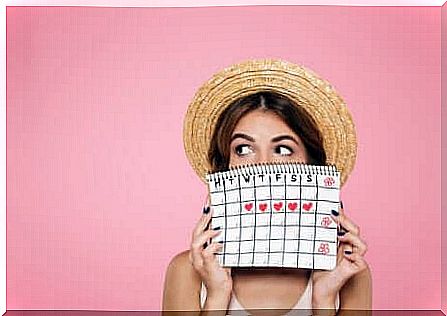 A woman taking note of the menstrual synchronization.