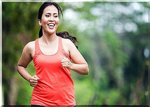 A smiling woman jogging